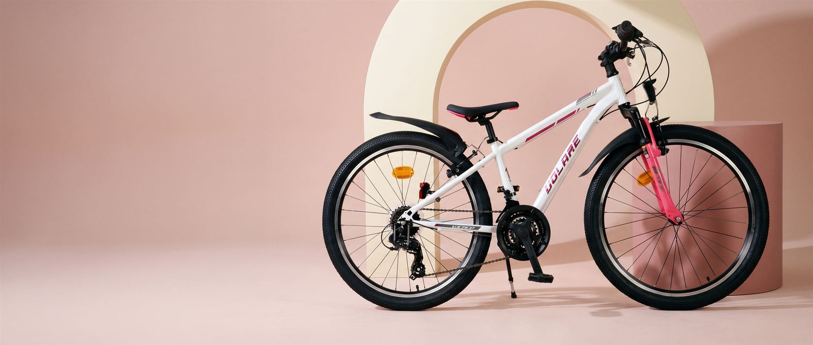Witte Volare kinderfiets met roze voorvork in een zachtroze studioset met creme boog